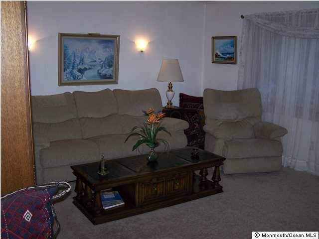 657 Thoroughfare Road Brick, NJ 08724 - Photo 14 of 23 a living room with furniture and a lamp