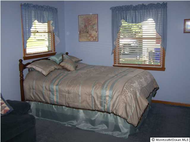 657 Thoroughfare Road Brick, NJ 08724 - Photo 16 of 23 a bedroom with a bed and a window