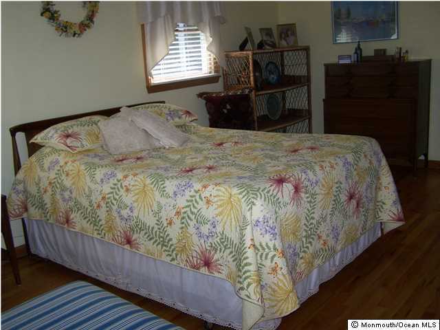 657 Thoroughfare Road Brick, NJ 08724 - Photo 17 of 23 a bed sitting in a bedroom next to a window