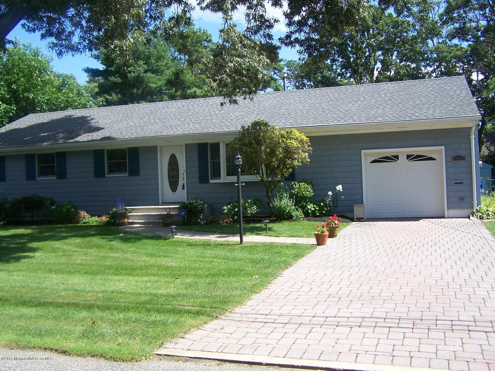 657 Thoroughfare Road Brick, NJ 08724 - Photo 21 of 23 a front view of a house with a yard and garage