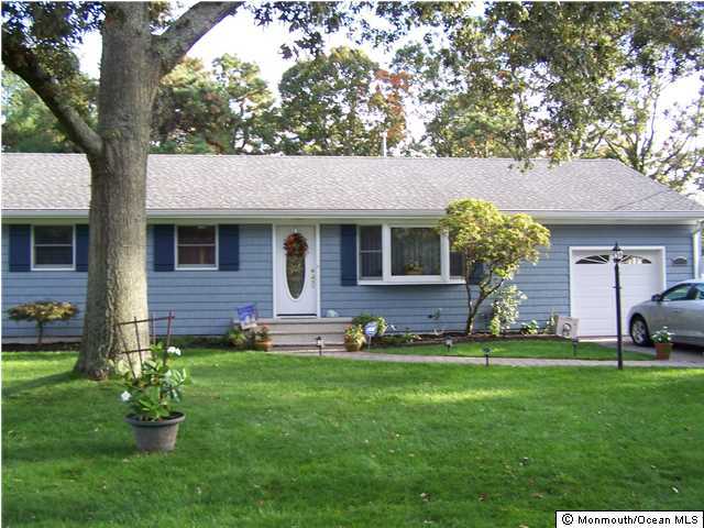657 Thoroughfare Road Brick, NJ 08724 - Photo 23 of 23 a front view of a house with a garden and trees