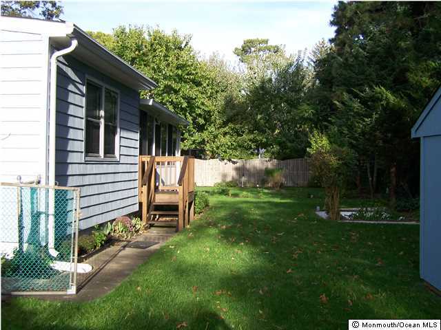 657 Thoroughfare Road Brick, NJ 08724 - Photo 4 of 23 a view of a back yard of the house