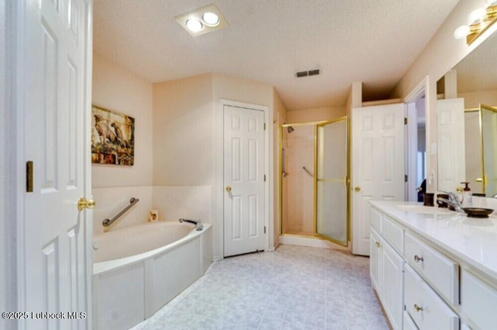 5914 88th Place Lubbock, TX 79424 - Photo 11 of 22 a spacious bathroom with a tub sink and mirror