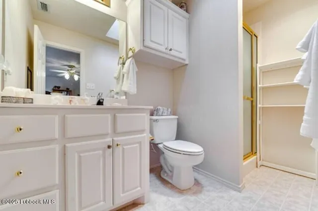 a bathroom with a sink a toilet a mirror and vanity