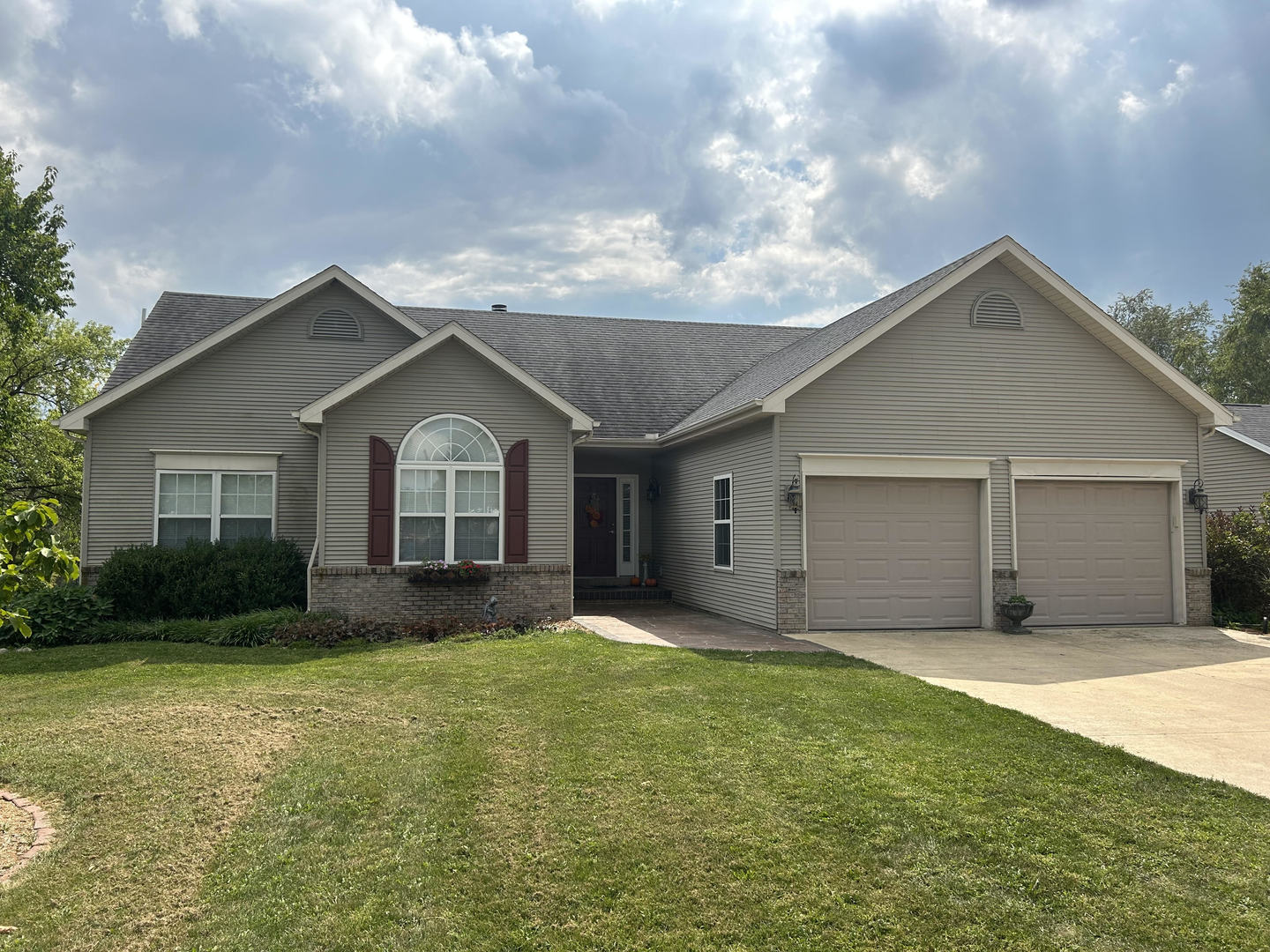 a front view of house with yard and green space