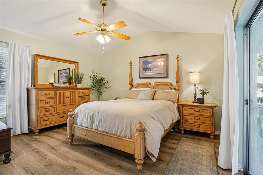 2052 Onecco Court Clermont, FL 34714 - Photo 11 of 33 a bedroom with a bed and a chandelier