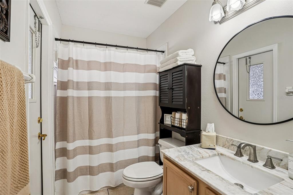 2052 Onecco Court Clermont, FL 34714 - Photo 17 of 33 a bathroom with a sink a toilet and a mirror