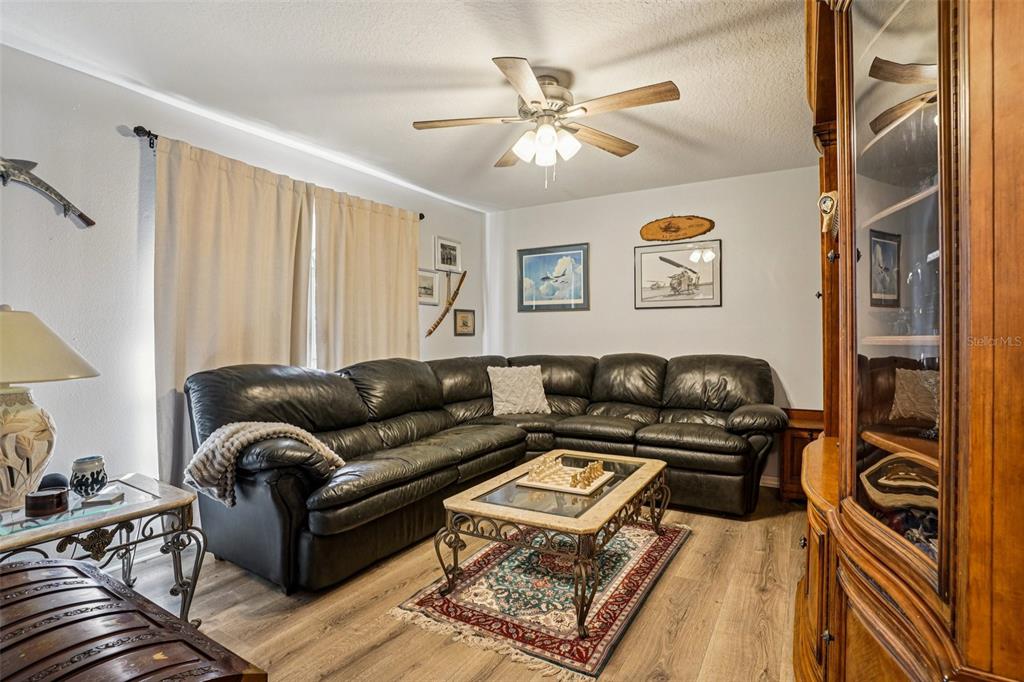 2052 Onecco Court Clermont, FL 34714 - Photo 19 of 33 a living room with furniture and a chandelier