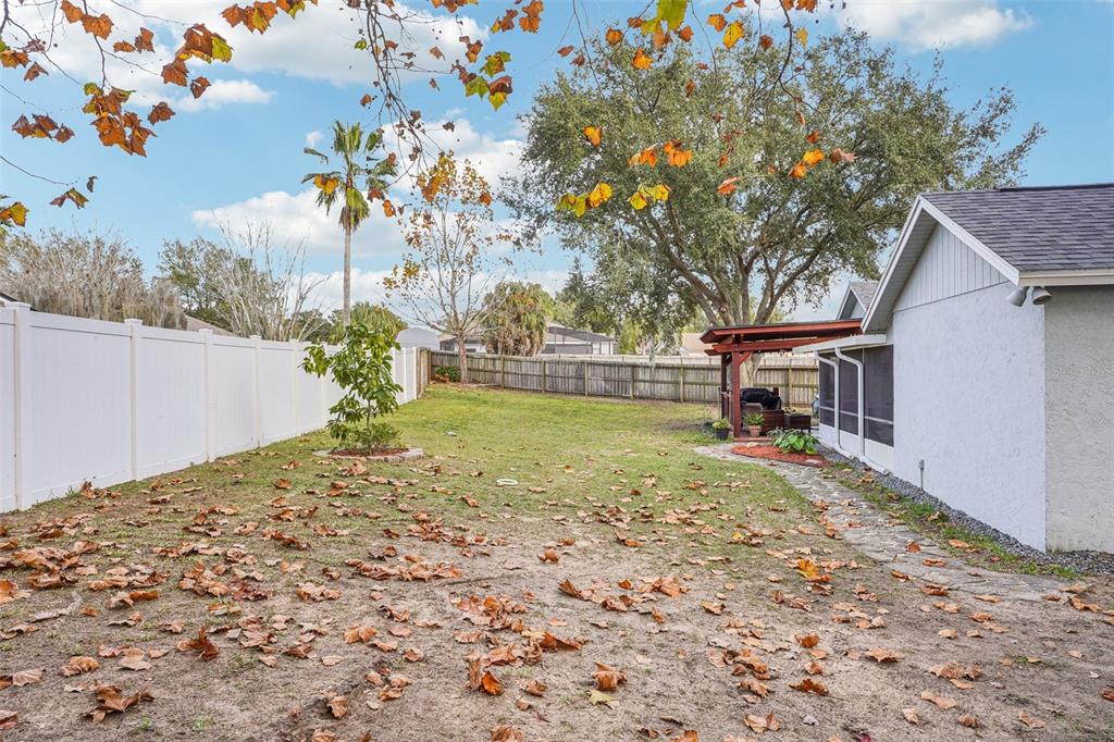 2052 Onecco Court Clermont, FL 34714 - Photo 28 of 33 a backyard of a house with table and chairs