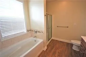 a bathroom with a bathtub and a window
