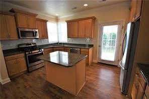 a kitchen with stainless steel appliances a sink stove and microwave