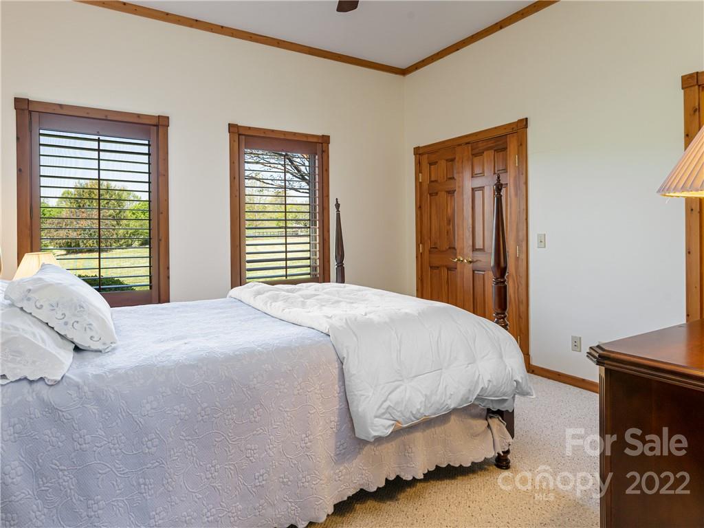 1030 Cane Creek Road Fletcher, NC 28732 - Photo 17 of 48 a bedroom with a bed and wooden floor