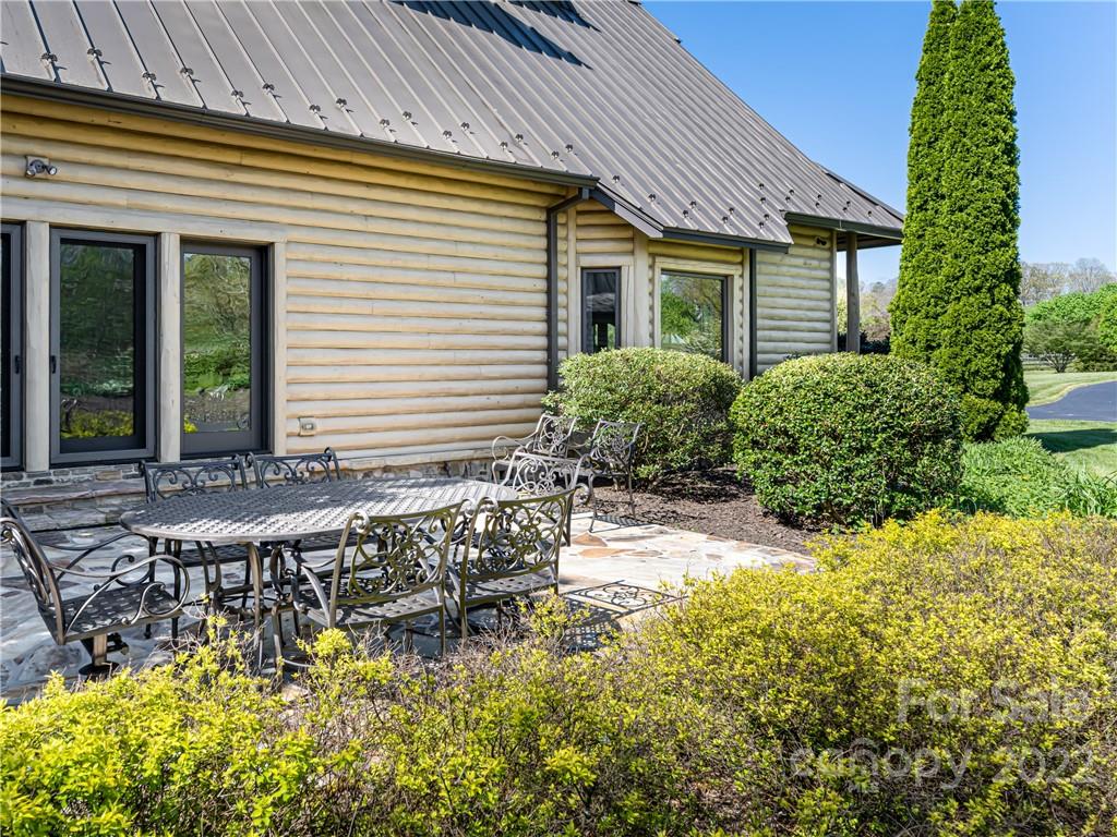 1030 Cane Creek Road Fletcher, NC 28732 - Photo 21 of 48 a view of a patio with table and chairs and potted plants