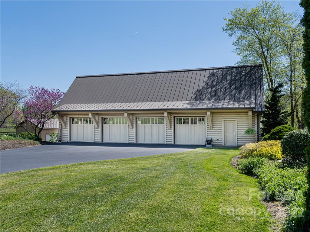 1030 Cane Creek Road Fletcher, NC 28732 - Photo 25 of 48 a view of a house with a yard and potted plants