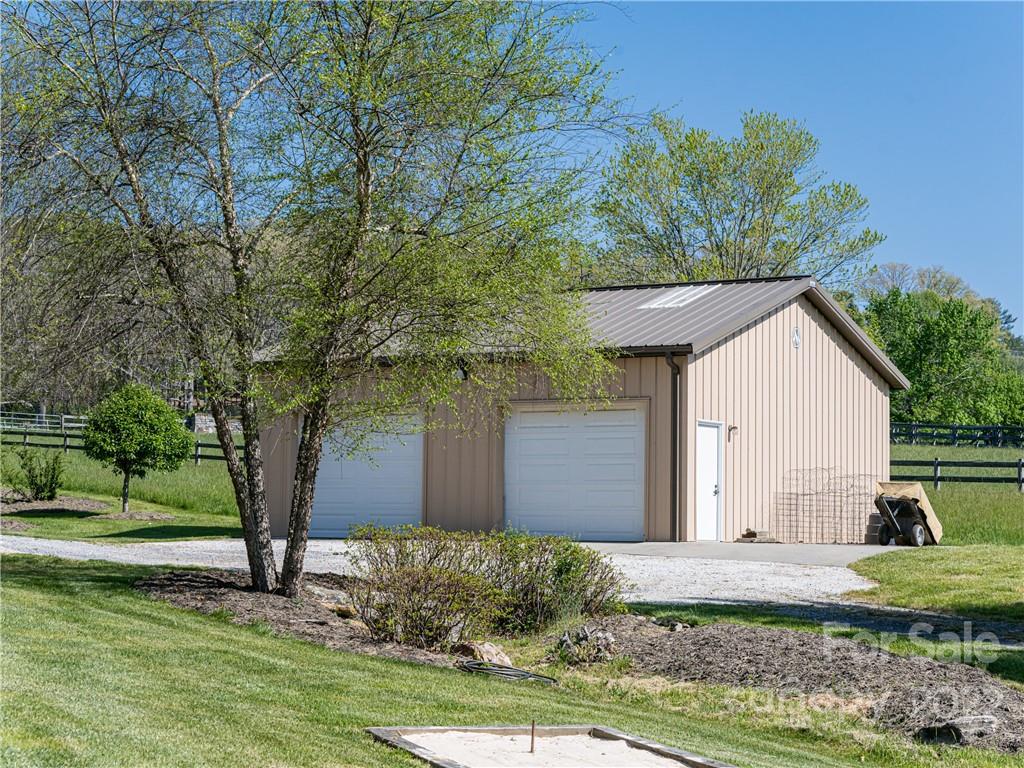 1030 Cane Creek Road Fletcher, NC 28732 - Photo 32 of 48 a front view of a house with garden