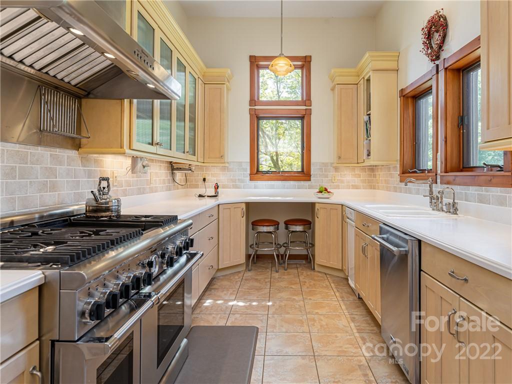 1030 Cane Creek Road Fletcher, NC 28732 - Photo 9 of 48 a kitchen with stainless steel appliances a stove sink and cabinets