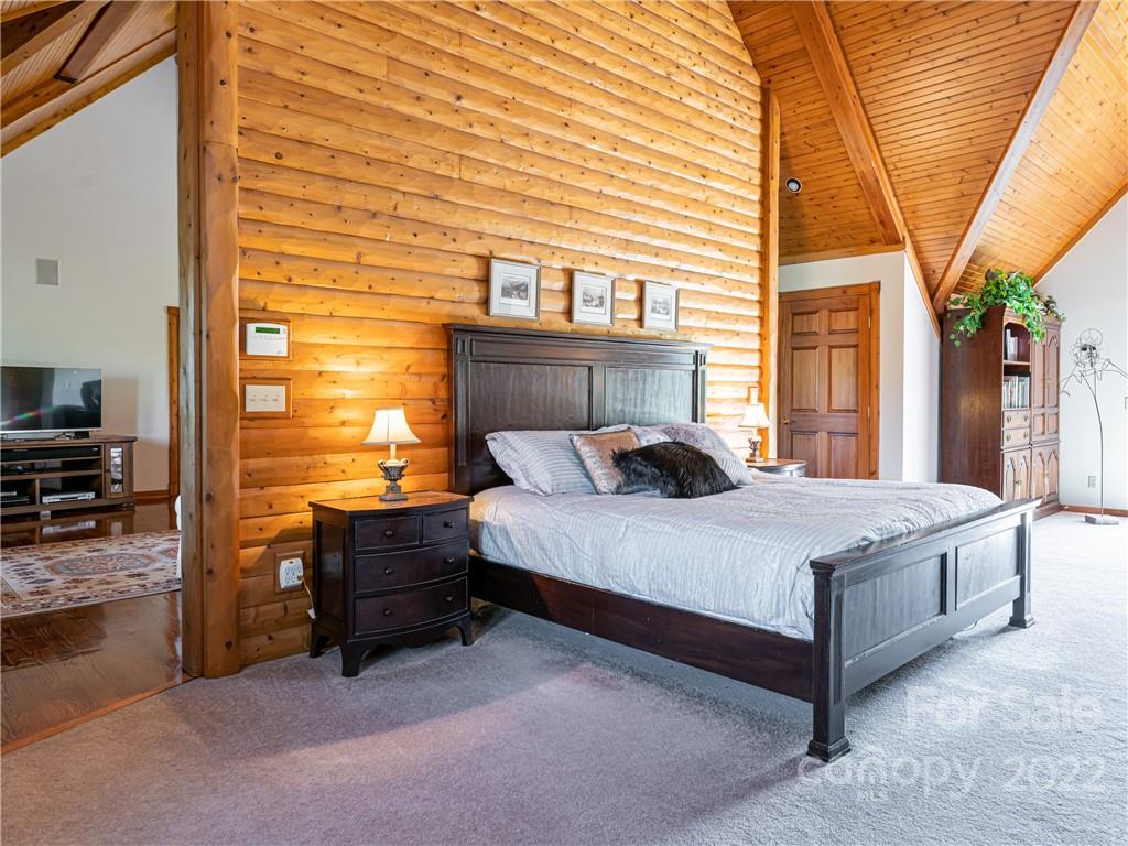 1030 Cane Creek Road Fletcher, NC 28732 - Photo 10 of 48 a bed sitting in middle of bedroom