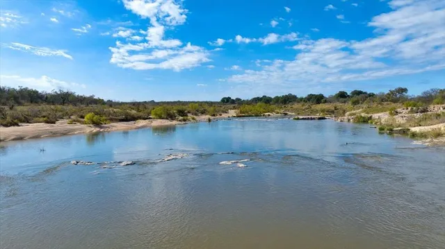 a table with wine bottles and glasses on it
