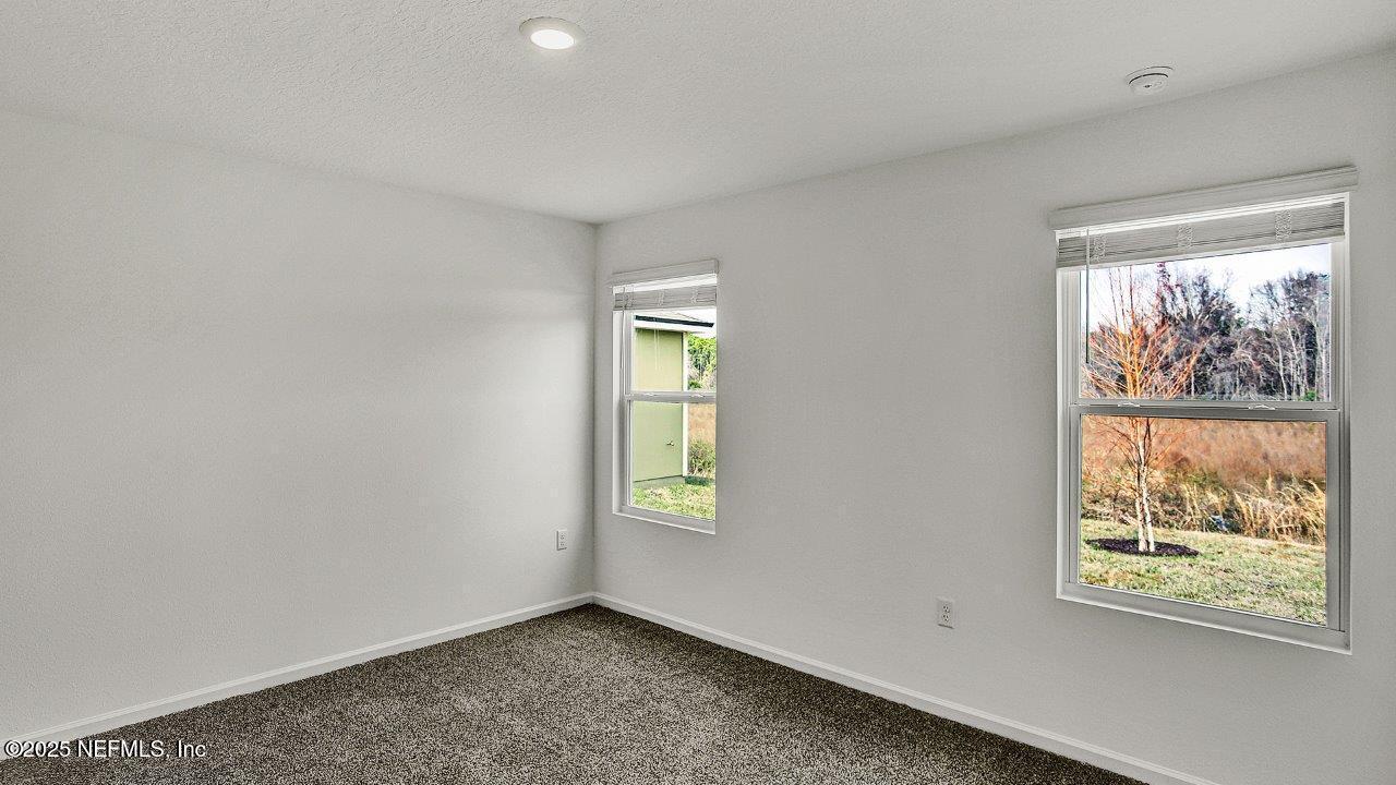 5645 Rustic Thorn Road Jacksonville, FL 32219 - Photo 7 of 45 an empty room with windows