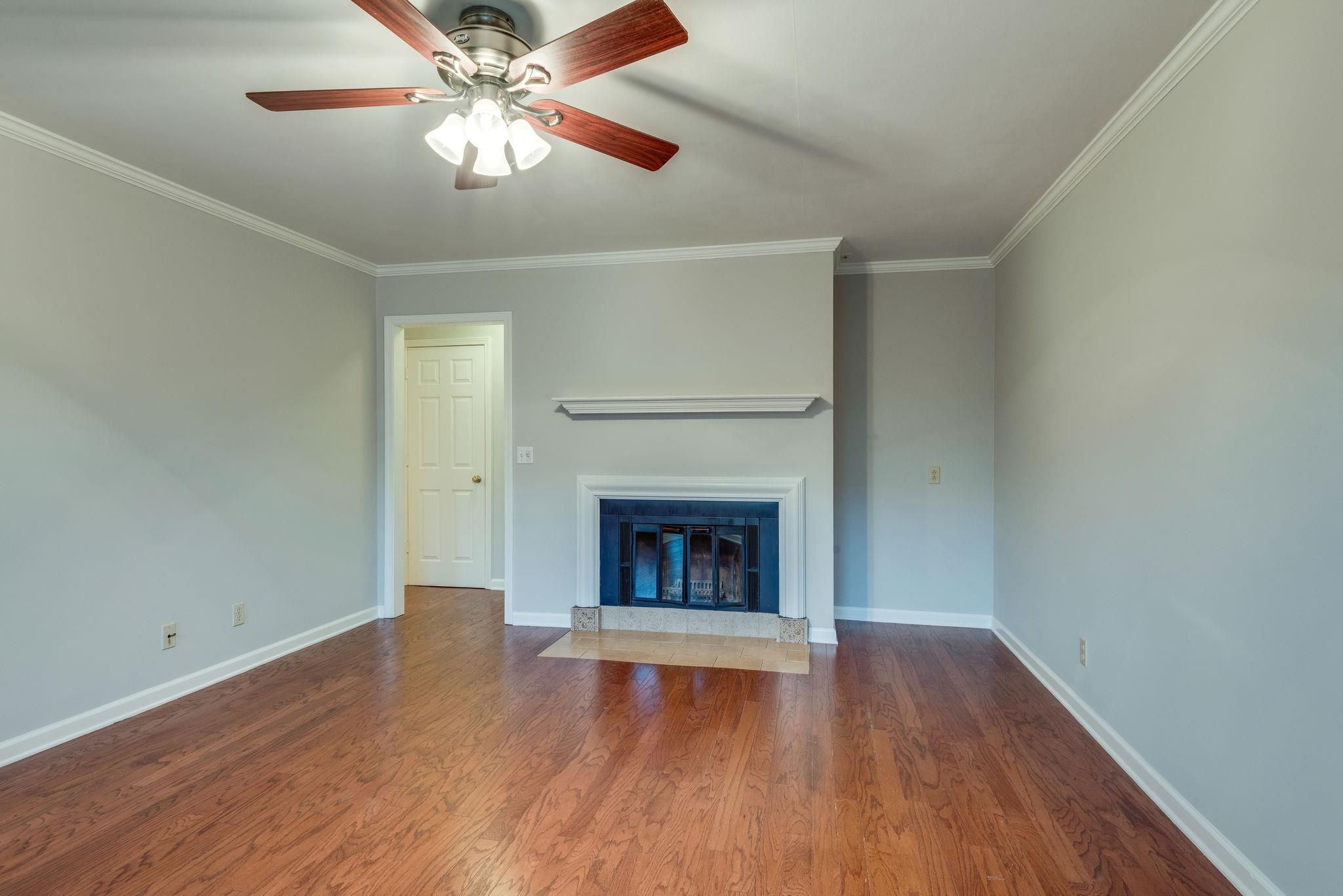 1012 General George Patton Road Nashville, TN 37221 - Photo 14 of 28 wooden floor fireplace and window in an empty room