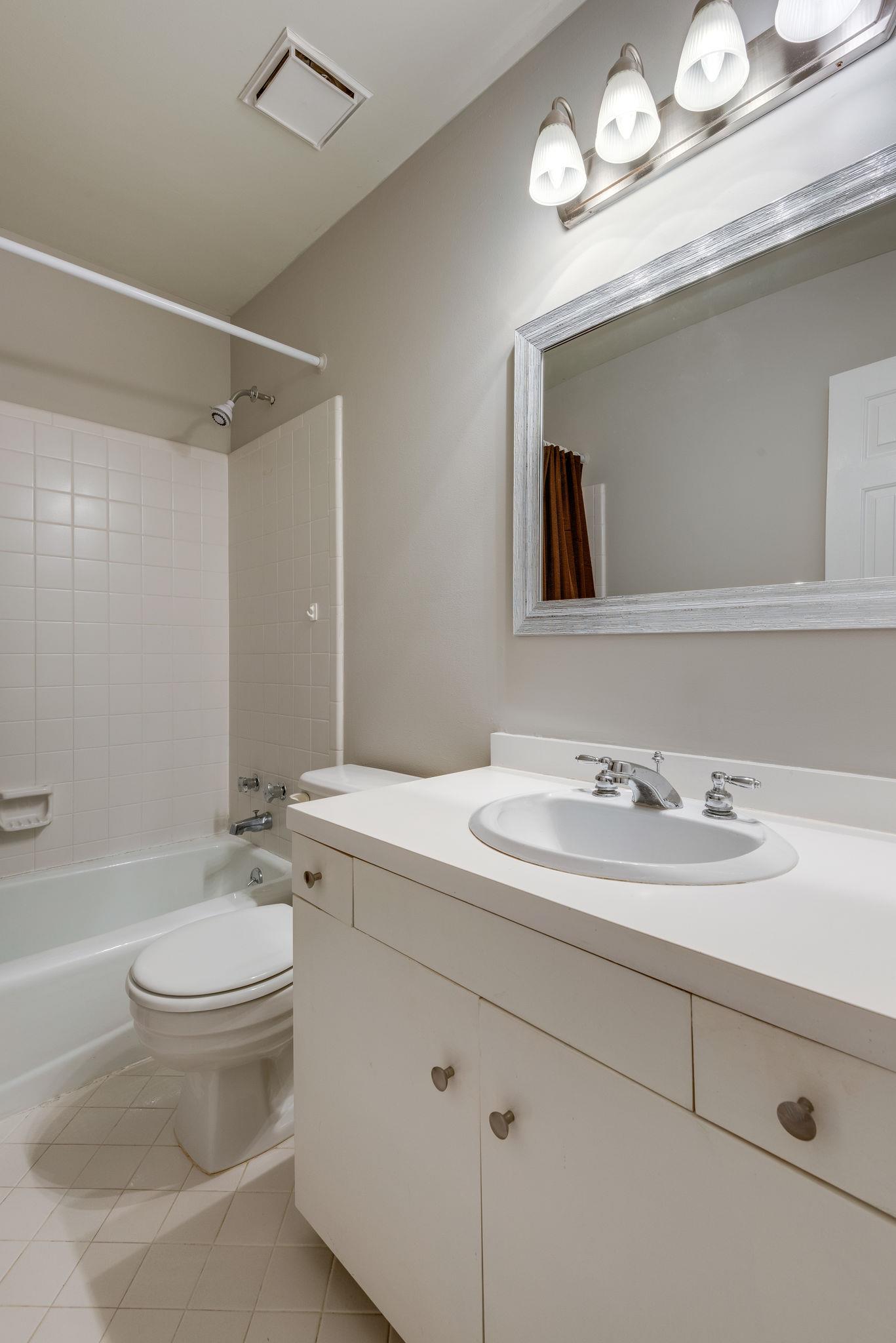 1012 General George Patton Road Nashville, TN 37221 - Photo 24 of 28 a bathroom with a toilet a sink a mirror and vanity