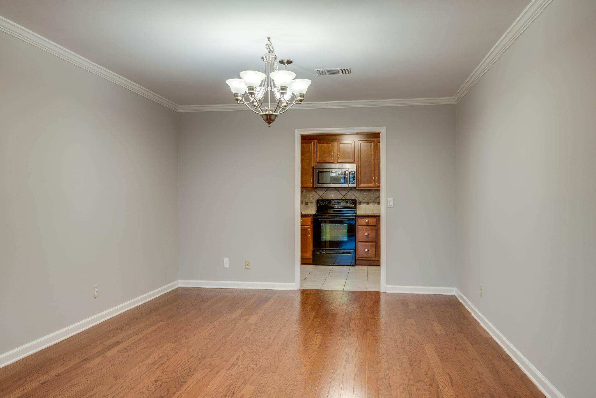 1012 General George Patton Road Nashville, TN 37221 - Photo 7 of 28 a view of a room with wooden floor and chandelier