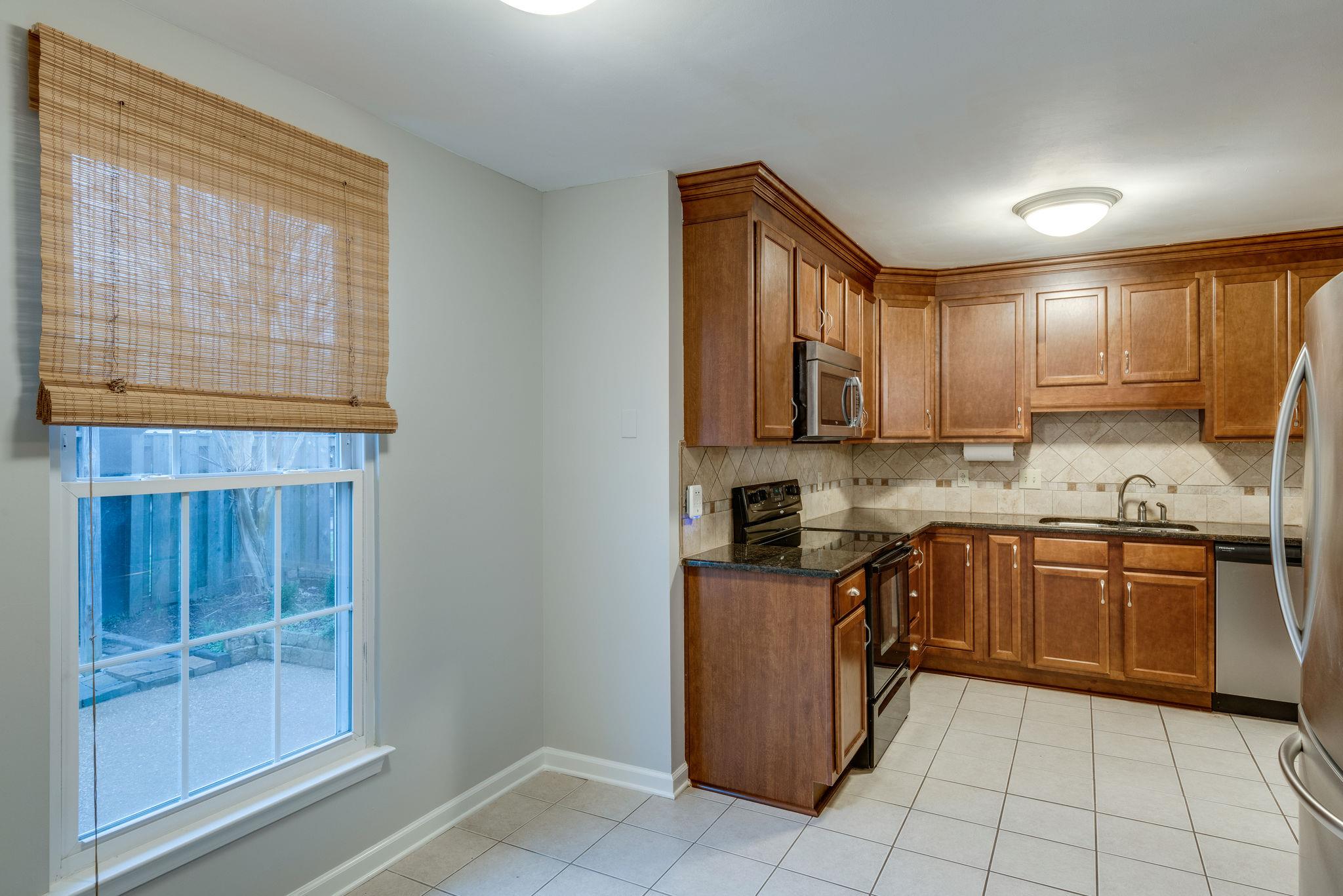 1012 General George Patton Road Nashville, TN 37221 - Photo 8 of 28 a kitchen with stainless steel appliances granite countertop a stove top oven a sink dishwasher and granite countertops