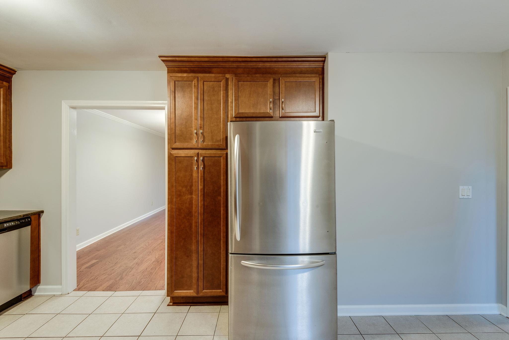 1012 General George Patton Road Nashville, TN 37221 - Photo 10 of 28 a view of a refrigerator in kitchen and an empty room