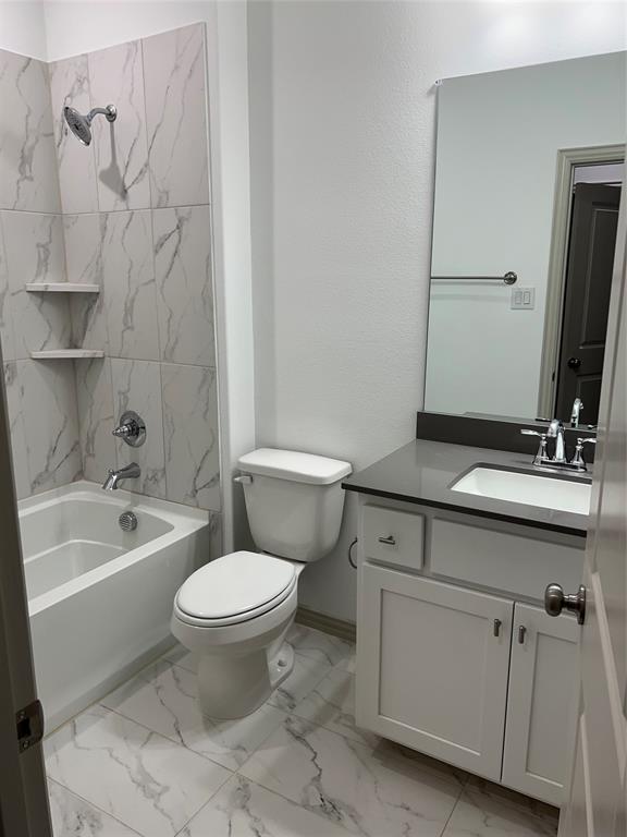 6041 Roper Road McKinney, TX 75070 - Photo 11 of 24 Full bathroom featuring a white tub with tiled shower surround, white vanity with dark countertop, and large wall-mounted mirror