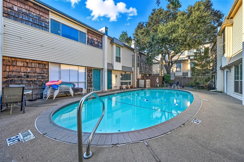 2702 Douglas Avenue, Unit 121 Dallas, TX 75219 - Photo 31 of 34 a view of a swimming pool with a patio
