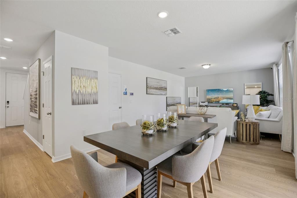 28005 Poppy Court Leesburg, FL 34748 - Photo 13 of 54 a view of a dining room with furniture and wooden floor