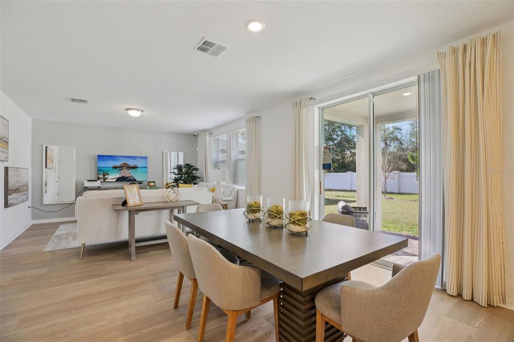28005 Poppy Court Leesburg, FL 34748 - Photo 14 of 54 a view of a dining room with furniture and wooden floor