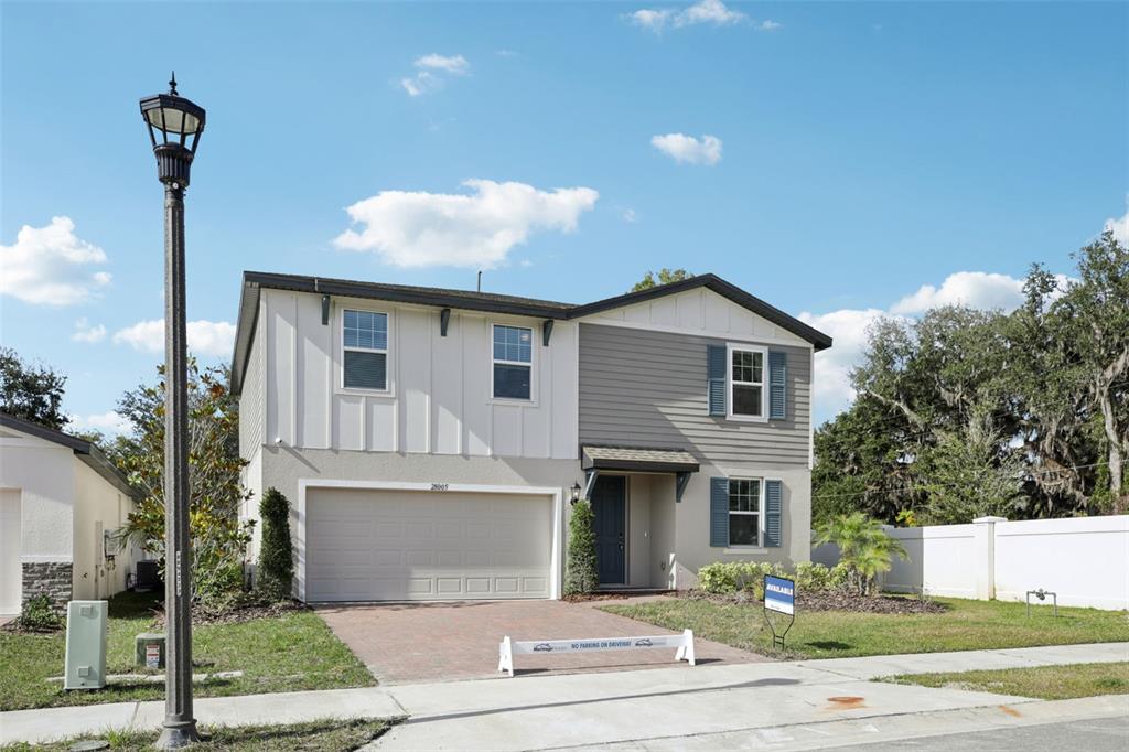28005 Poppy Court Leesburg, FL 34748 - Photo 2 of 54 a front view of a house with a garden