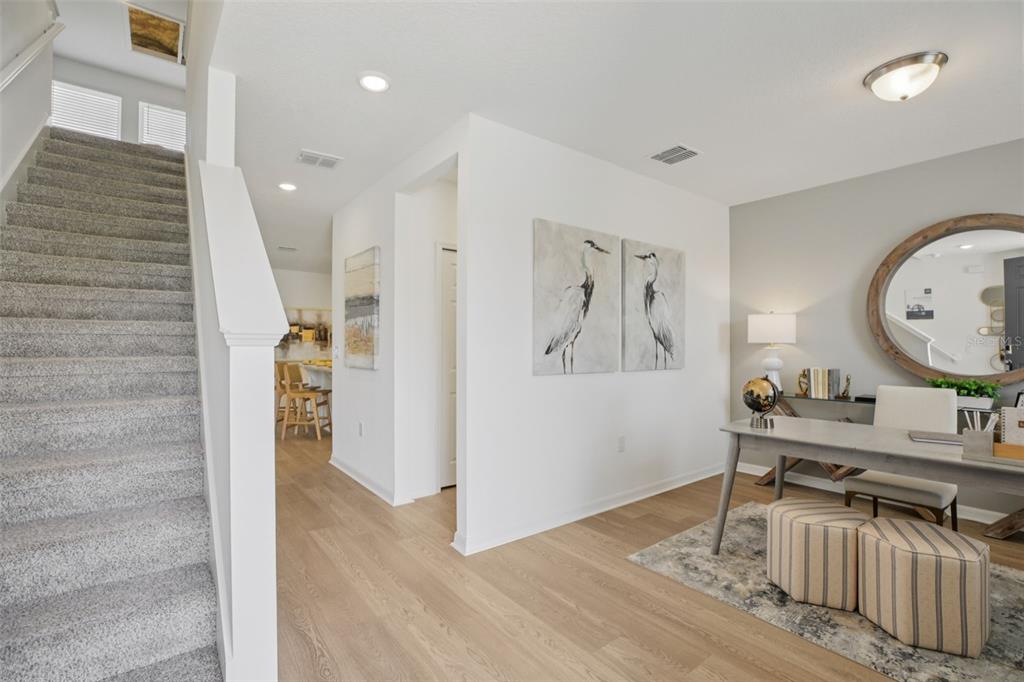 28005 Poppy Court Leesburg, FL 34748 - Photo 22 of 54 a living room with furniture and a wooden floor
