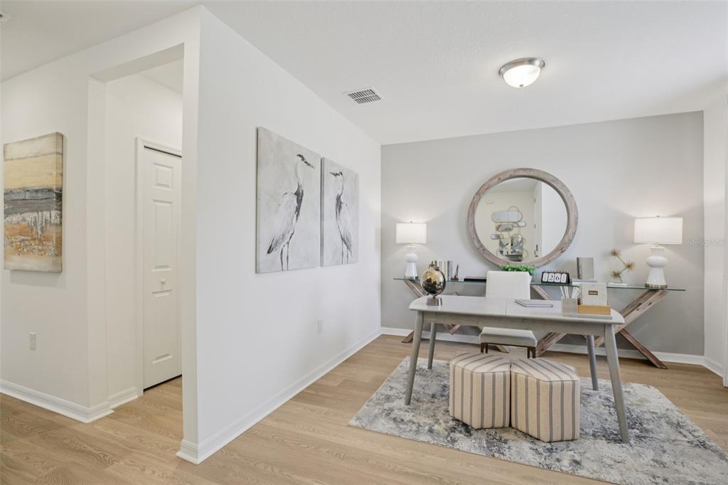 28005 Poppy Court Leesburg, FL 34748 - Photo 24 of 54 a living room with furniture a mirror and a table