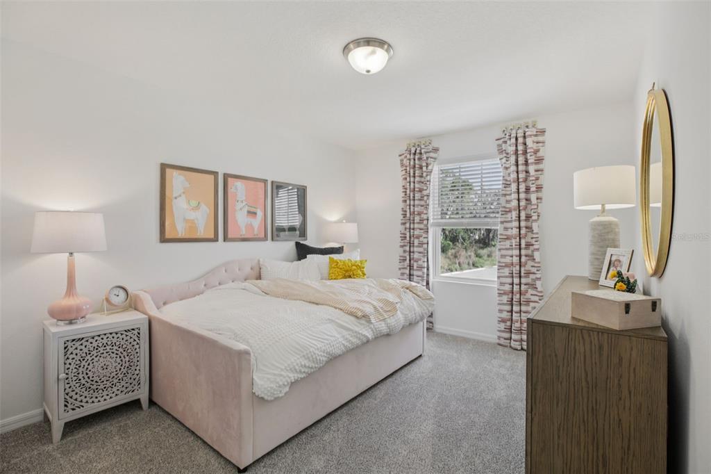 28005 Poppy Court Leesburg, FL 34748 - Photo 29 of 54 a bedroom with a bed a mirror and a window