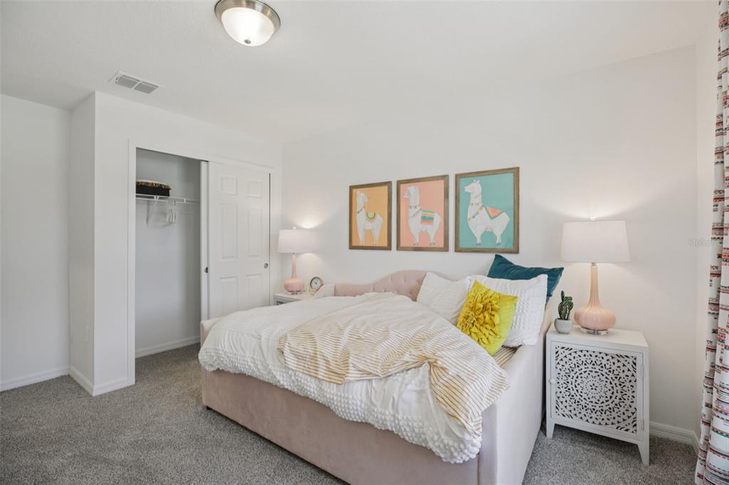 28005 Poppy Court Leesburg, FL 34748 - Photo 30 of 54 a bedroom with a bed and a lamp