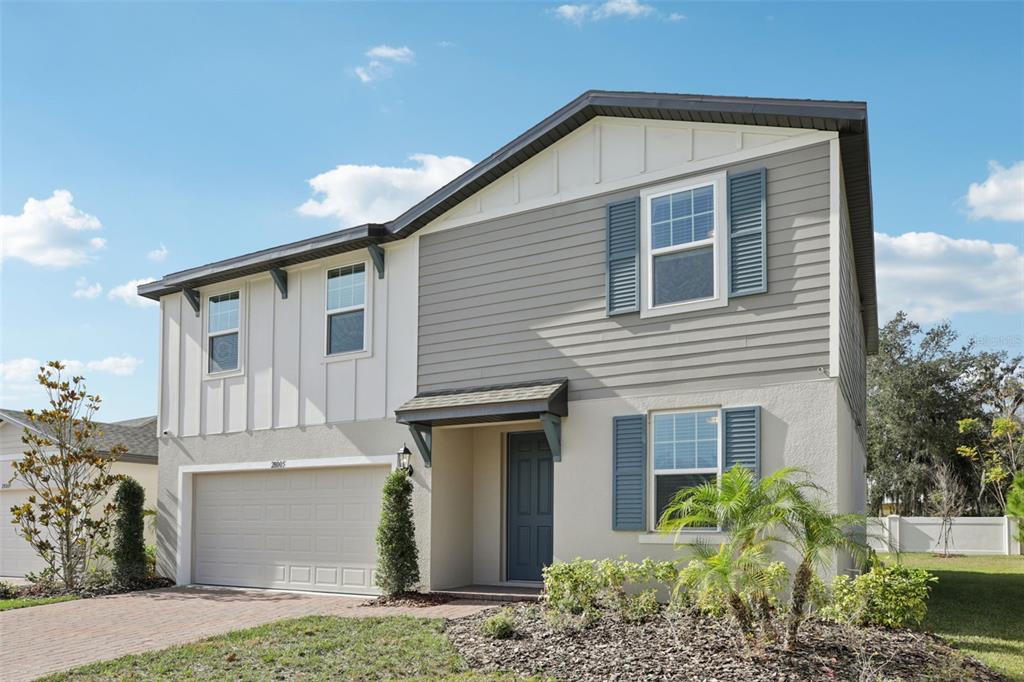 28005 Poppy Court Leesburg, FL 34748 - Photo 3 of 54 a front view of a house with garden