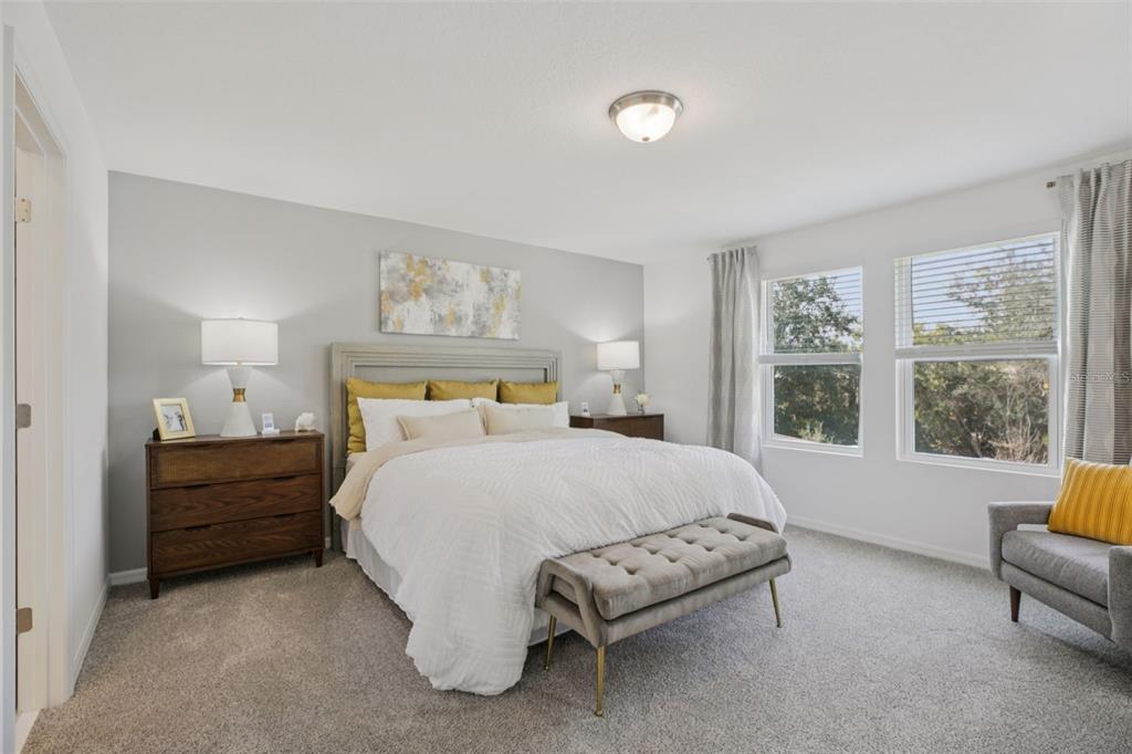 28005 Poppy Court Leesburg, FL 34748 - Photo 34 of 54 a bedroom with a bed and a couch