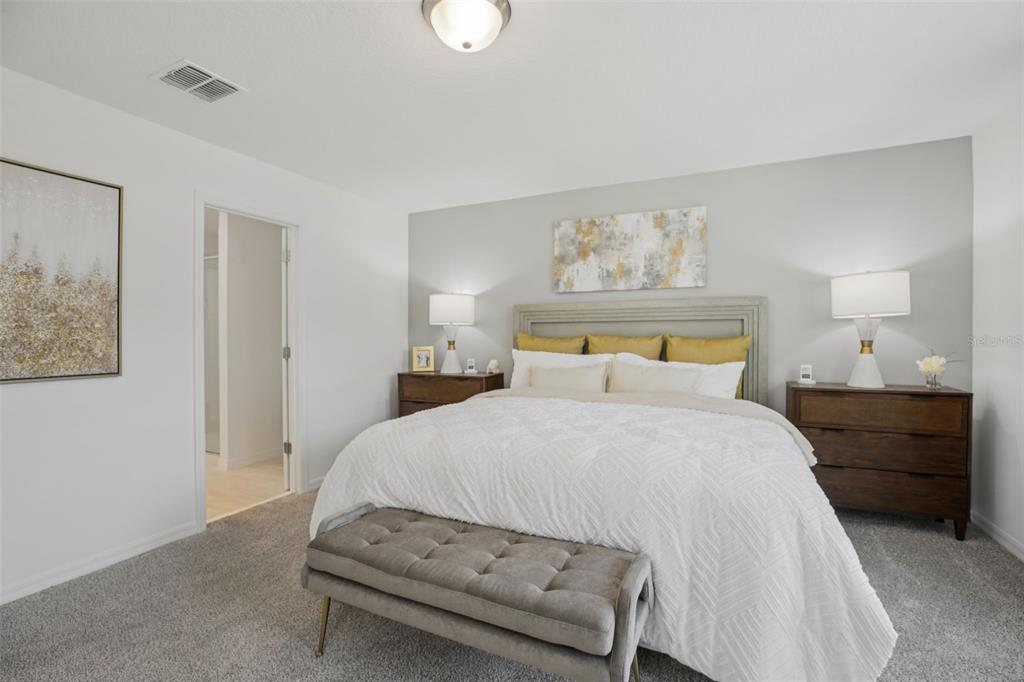 28005 Poppy Court Leesburg, FL 34748 - Photo 35 of 54 a bedroom with a bed and a night stand