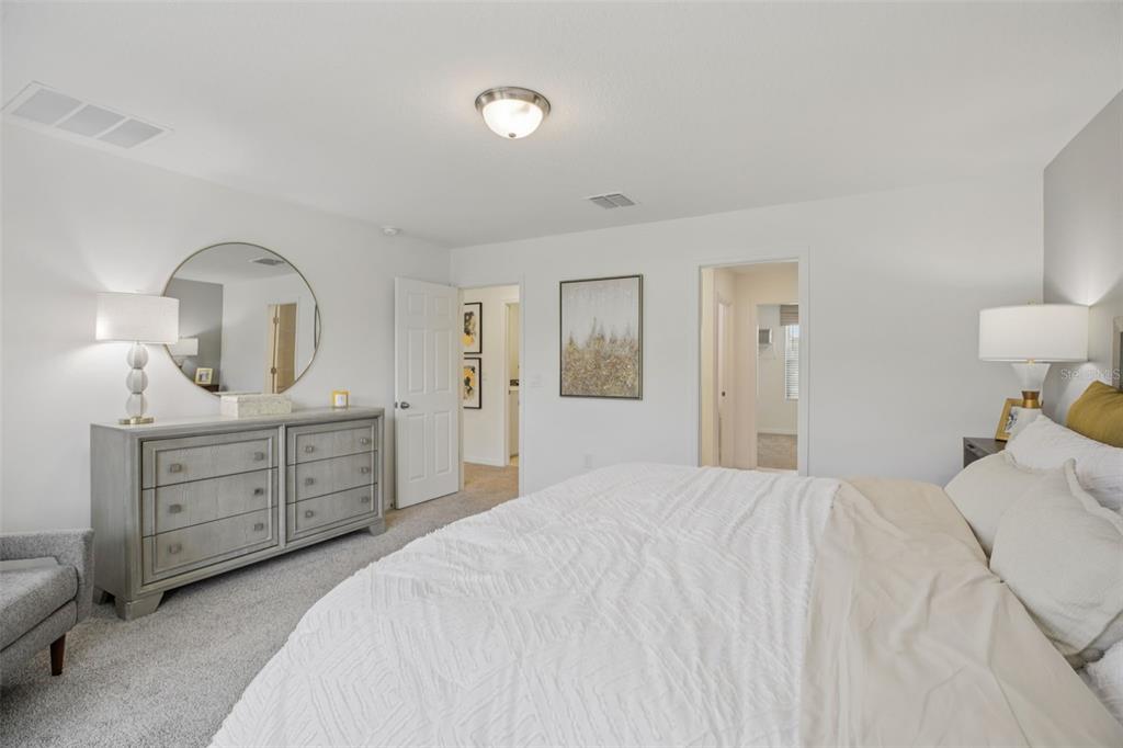 28005 Poppy Court Leesburg, FL 34748 - Photo 36 of 54 a bedroom with a bed and a dresser