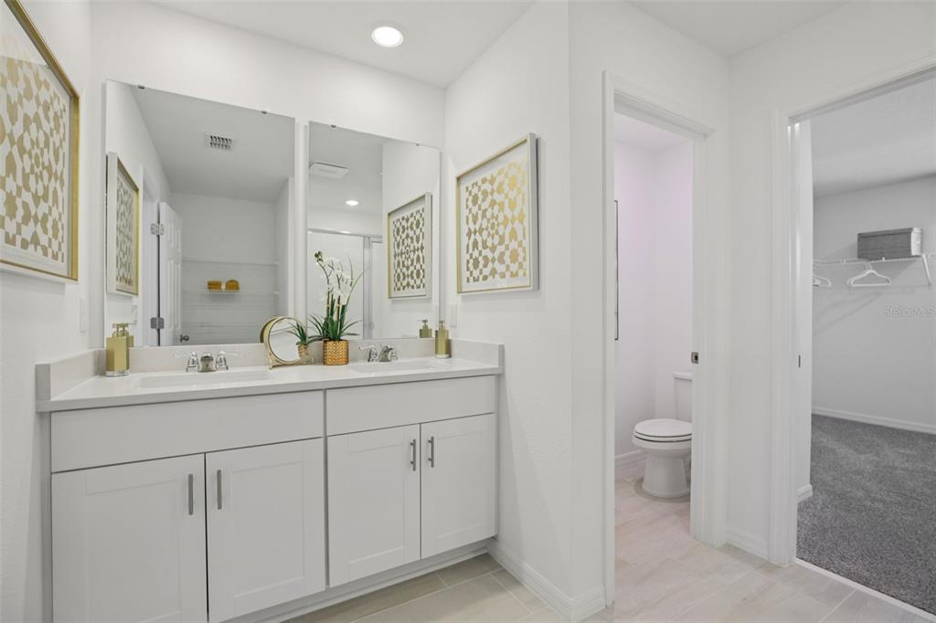 28005 Poppy Court Leesburg, FL 34748 - Photo 40 of 54 a bathroom with a toilet sink and mirror