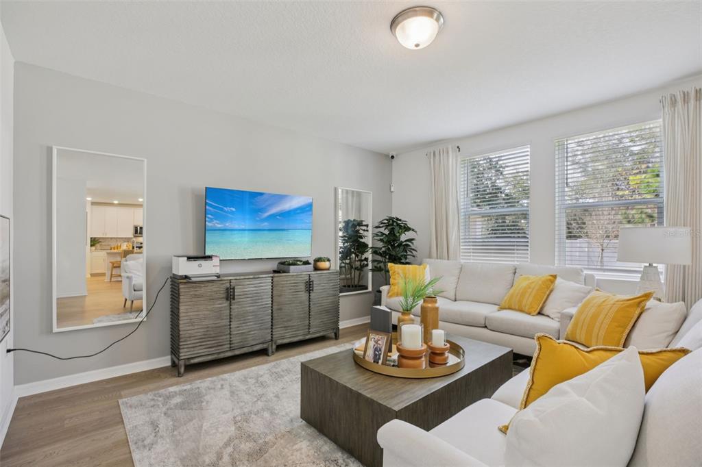 28005 Poppy Court Leesburg, FL 34748 - Photo 6 of 54 a living room with furniture and a flat screen tv