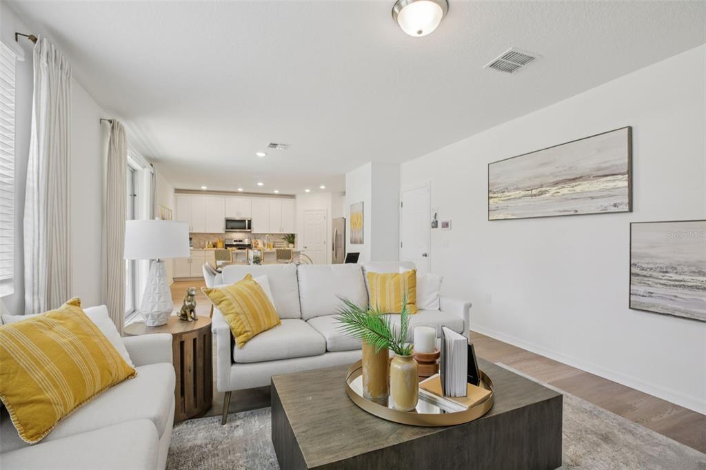 28005 Poppy Court Leesburg, FL 34748 - Photo 8 of 54 a living room with furniture and kitchen view