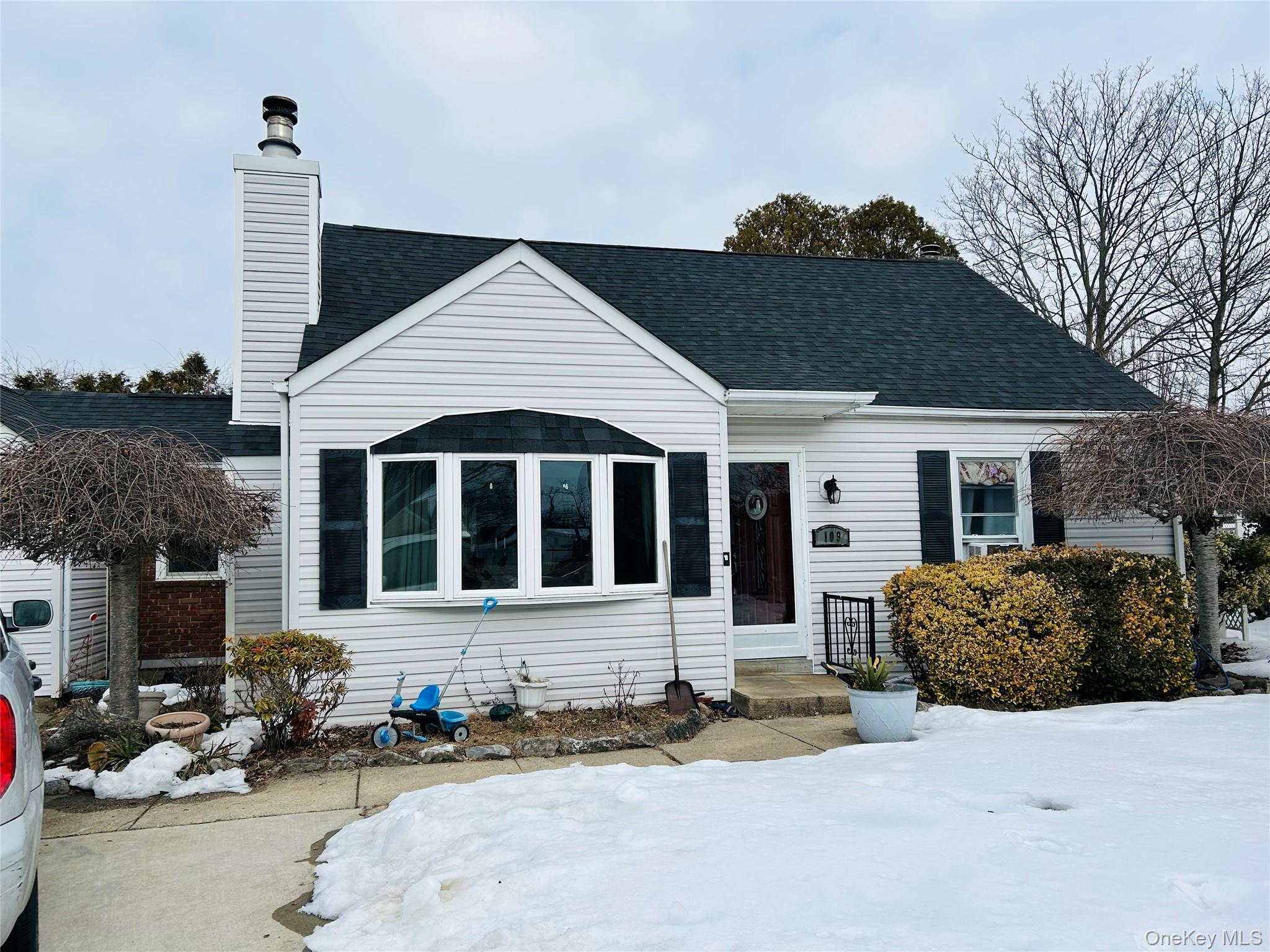 109 Vesper Court Babylon, NY 11702 - Photo 1 of 3 a front view of a house with a yard and glass windows