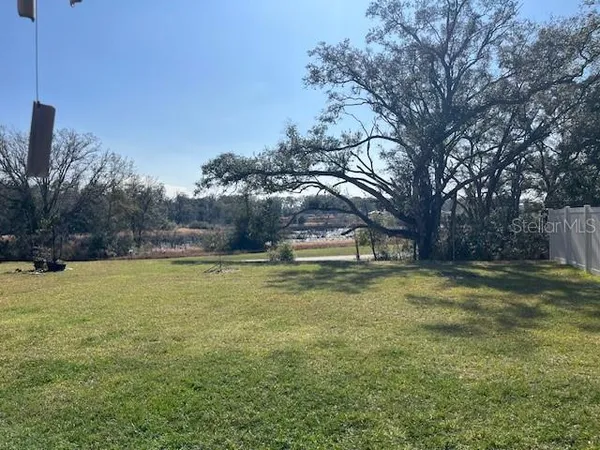 a small pool with trees in the background