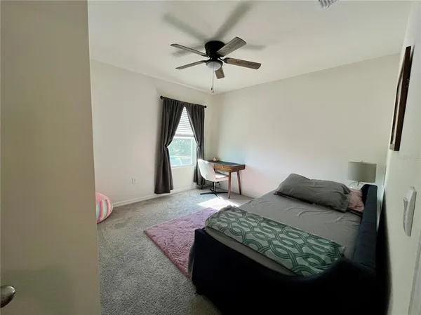 a bedroom with a bed and window