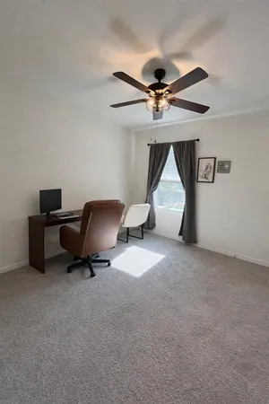 a living room with furniture and a ceiling fan