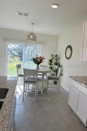 a dining room with granite countertop furniture and a large window