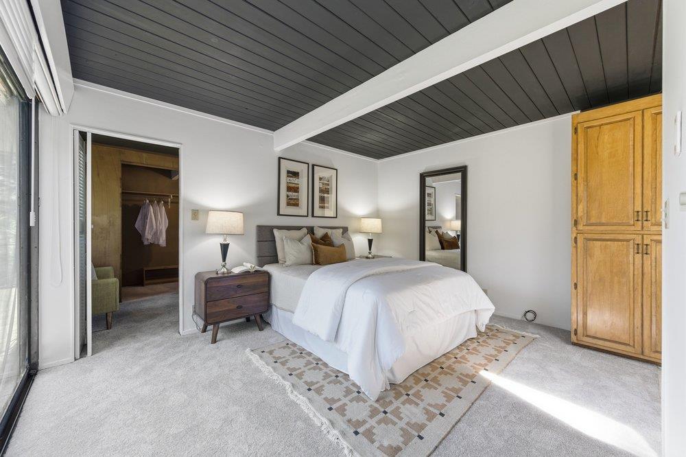 2203 Allegheny Way San Mateo, CA 94402 - Photo 19 of 56 a spacious bedroom with a bed and dresser with mirror